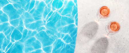 Refreshing rose wine by the pool on a sunny day, the perfect summer vacation. View from above with space for your textの写真素材