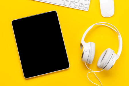 Gaming gear and tech accessories on a yellow background, perfect for gaming and tech-related themes. flat layの写真素材