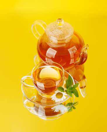 Soothing herbal tea blend with mint and chamomile. On yellow backgroundの写真素材