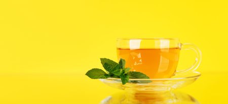 Soothing herbal tea blend with mint. On yellow background with copy spaceの写真素材