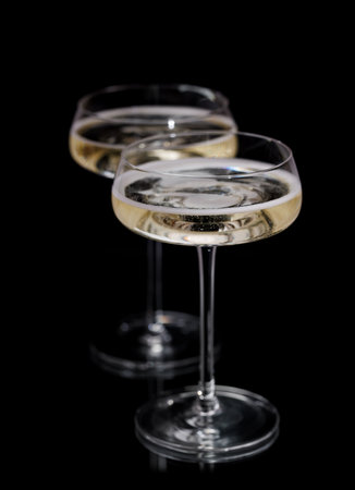Two champagne glasses on a black backgroundの写真素材
