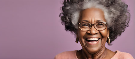 Smiling elderly African woman on plain background with copy spaceの素材