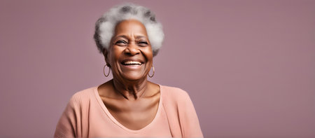 Smiling elderly African woman on plain background with copy spaceの素材