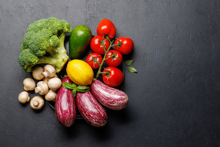 Variety of vegetables. Flat lay over dark stone background with copy spaceの写真素材