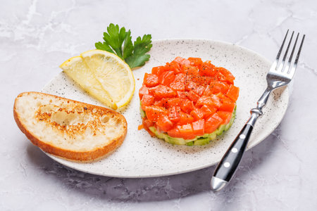 Delicious salmon and avocado tartare with crispy toastsの写真素材