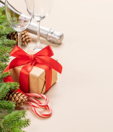 Xmas fir tree branch, Christmas gift box, champagne and space for greetings textの写真素材