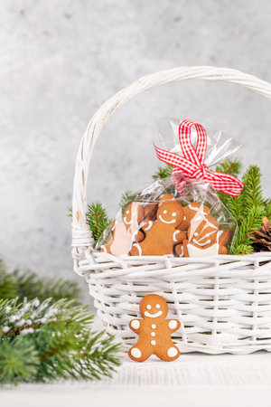 Basket with Christmas gingerbread cookies fir tree branches. With space for your Xmas greetingsの写真素材
