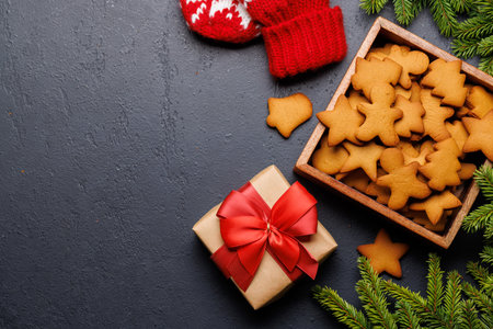 Gingerbread cookies and fir tree branch. Christmas holiday card with copy spaceの写真素材
