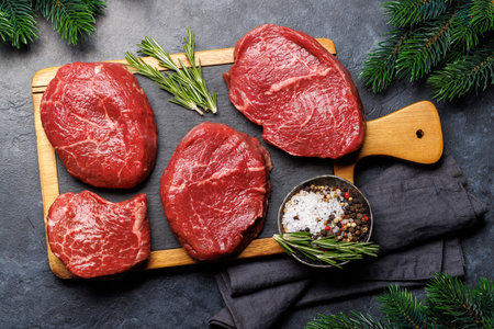 Raw beef fillet steaks on a cutting board, fresh and uncooked. Holiday cookingの写真素材