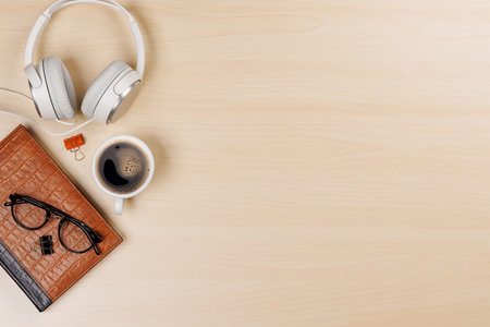 Workplace essentials: Coffee, notepad and supplies. Flat lay with copy spaceの写真素材