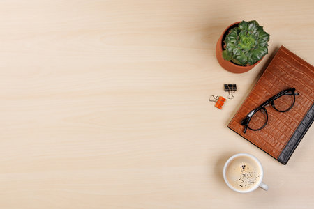 Workplace essentials: Coffee, notepad and supplies. Flat lay with copy spaceの写真素材