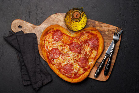 Heart-shaped pizza: Delicious love-themed dish. Flat layの写真素材
