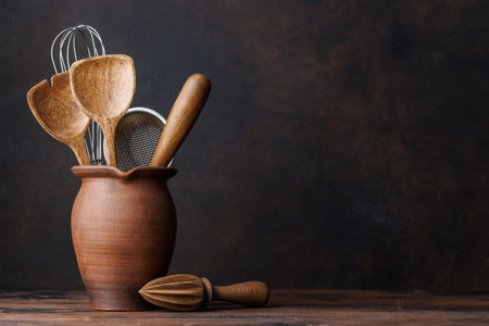 Culinary essentials: Diverse cooking utensils on kitchen table. With copy spaceの写真素材