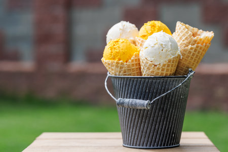 Assorted ice cream flavors in delightful waffle cones, a treat for every taste bud. Outdoor with copy spaceの写真素材