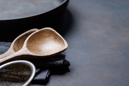 Culinary essentials: Diverse cooking utensils on stone table. With copy spaceの写真素材