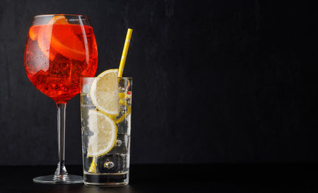 spritz and gin tonic cocktails on black with copy spaceの写真素材