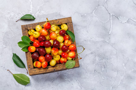 A vibrant and colorful cherry, bursting with sweet juiciness. On sunny outdoor garden table. Flat lay with copy spaceの写真素材