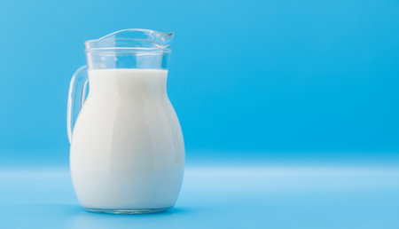 Fresh Milk in Pitcher on blue background with copy spaceの写真素材
