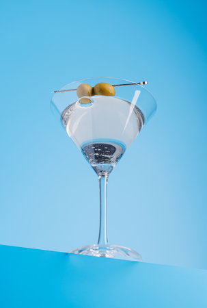 Cocktail delight: Classic martini against a cool blue backgroundの写真素材