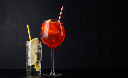 spritz and gin tonic cocktails on black with copy spaceの写真素材