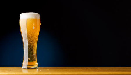Beer on the bar: Refreshing draft brew on a wooden table. With copy spaceの写真素材