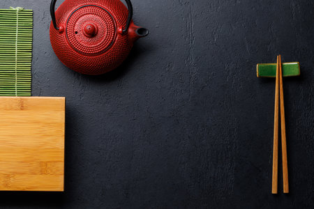 Japanese Table Setting with Wooden Board, Teapot, Chopsticks, and Copy Space, Flat Layの写真素材