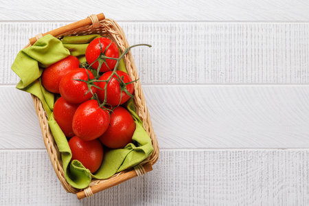 Fresh tomatoes in basket. Flat lay with copy spaceの写真素材