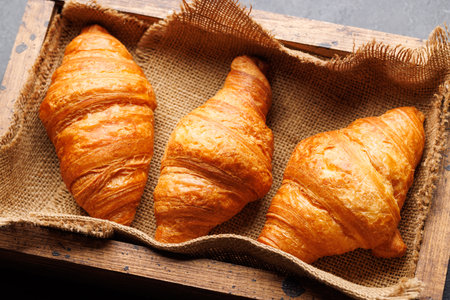 Fresh croissants in wooden boxの写真素材