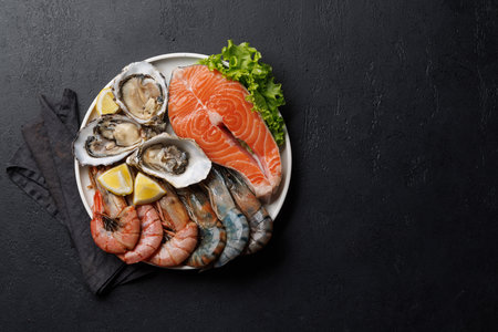 Seafood Platter Delight: Shrimps, Salmon, Oysters Galore. Flat lay with copy spaceの写真素材