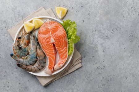 Seafood Platter Delight: Shrimps and Salmon. Flat lay with copy spaceの写真素材