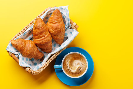 Cappuccino coffee and fresh croissants. Flat lay with copy spaceの写真素材