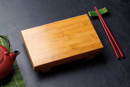 Japanese Table Setting with Wooden Board, Teapot, Chopsticksの写真素材