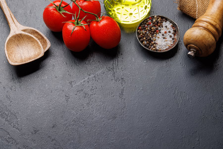 Spices, olive oil, ingredients and utensils on cooking table. With copy spaceの写真素材