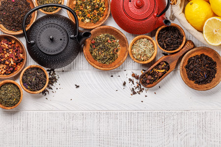 A collection of various teas nestled in wooden bowls. Flat lay with copy spaceの写真素材