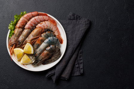 Raw shrimps on plate, ready to cook. Flat lay with copy spaceの写真素材