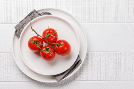 Fresh tomatoes on plate. Flat lay with copy spaceの写真素材