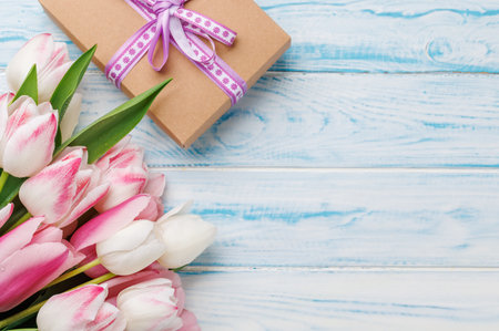 Pastel colorful tulips grace the table, providing a serene and vibrant backdrop, perfect for spring celebrations or simple joysの写真素材