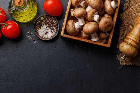 Spices, olive oil, ingredients and utensils on cooking table. Flat lay with copy spaceの写真素材