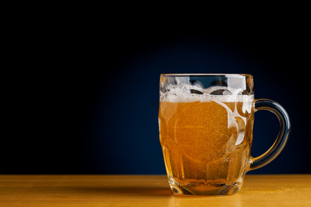 Beer on the bar: Refreshing draft brew on a wooden table. With copy spaceの写真素材