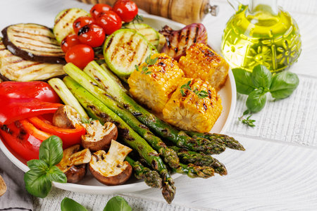 Assorted grilled vegetables on a plate, showcasing a colorful and healthy mealの写真素材
