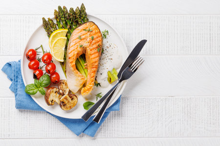 Grilled salmon steak over grilled asparagus, a delicious and healthy meal. With copy spaceの写真素材