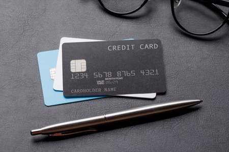 Credit cards on office table with supplies. Banking conceptの写真素材