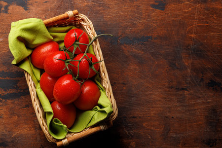 Fresh tomatoes in basket. Flat lay with copy spaceの写真素材