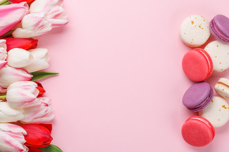 Pastel colorful tulips and vibrant macaroons, offering a delightful and charming scene perfect for celebrations or joyful momentsの写真素材