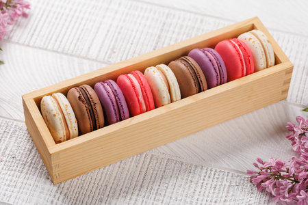 Colorful macaroons in box, arranged in a delightful display of vibrant hues and irresistible sweetnessの写真素材