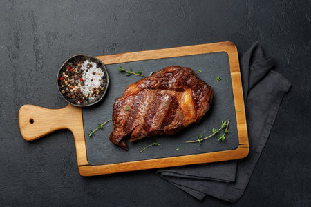 Deliciously juicy beef ribeye steak, perfectly cooked and ready to be savored. Flat layの写真素材