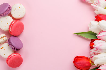 Pastel colorful tulips and vibrant macaroons, offering a delightful and charming scene perfect for celebrations or joyful momentsの写真素材