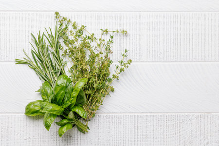 Various herbs and spices on the table, adding vibrant colors and rich aromas to the kitchen. With copy spaceの写真素材