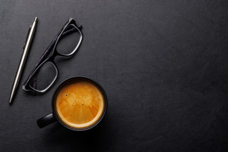 Office desk table with coffee cup and supplies. Top view with copy space. Flat layの写真素材