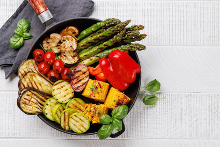 Assorted grilled vegetables on a frying pan, showcasing a colorful and healthy meal. Flat lay with copy spaceの写真素材